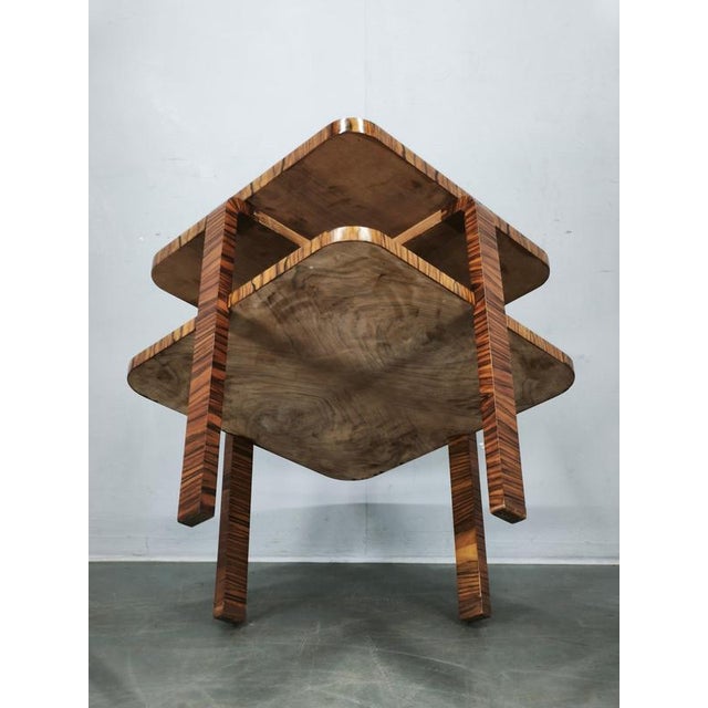 Elegant Art Deco walnut coffee table, produced in Czechoslovakia during the 1930s. The table features a distinctive...