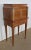 Small cabinet with rounded and recessed sides. It is composed of two curtained doors, sliding on the sides, with bronze...