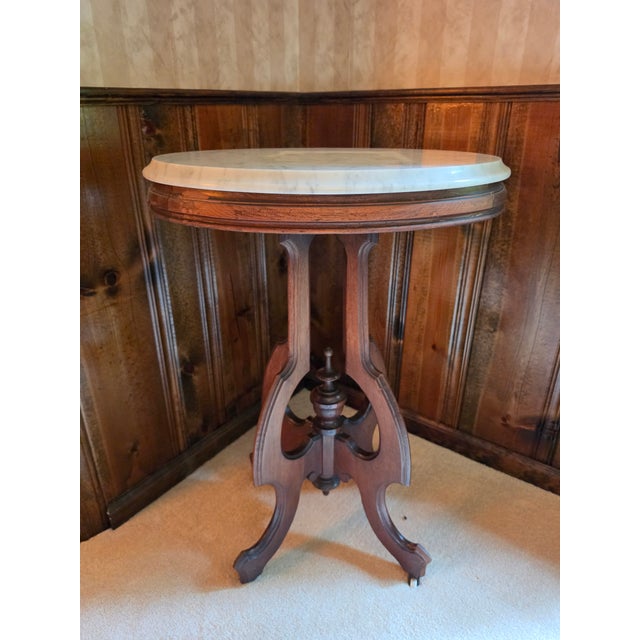 An elegant American Victorian parlor center table dating to circa 1875, beautifully blending Renaissance Revival...