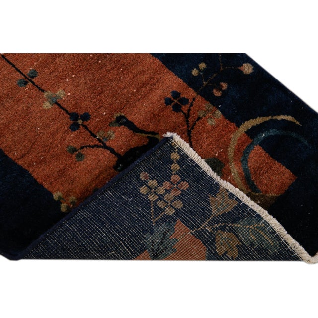 Beautiful Antique Art Deco Hand-knotted Wool Rug with the tan field. This Chinese rug has a navy-blue frame and multicolor...