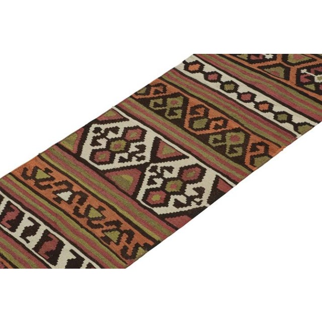 This vintage 2x11 Persian Kilim runner is believed to be a Shahsavan tribal rug. Handwoven in wool, it originates circa...