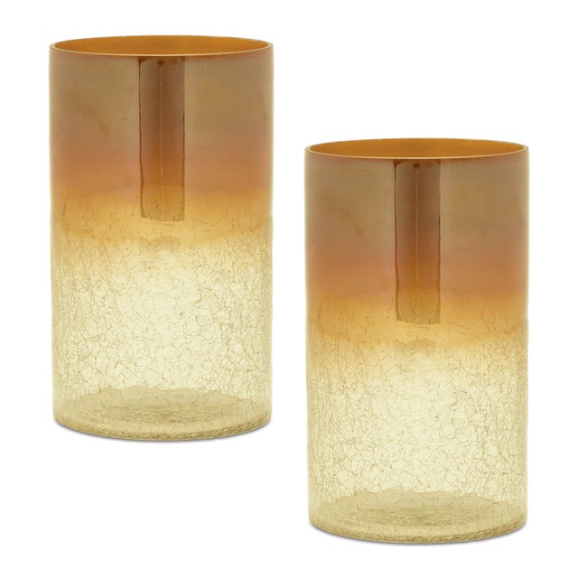 Bring a touch of luxury and modern flair to your home with the Crackle Glass Candle Holders. Standing at 7.5 inches tall,...