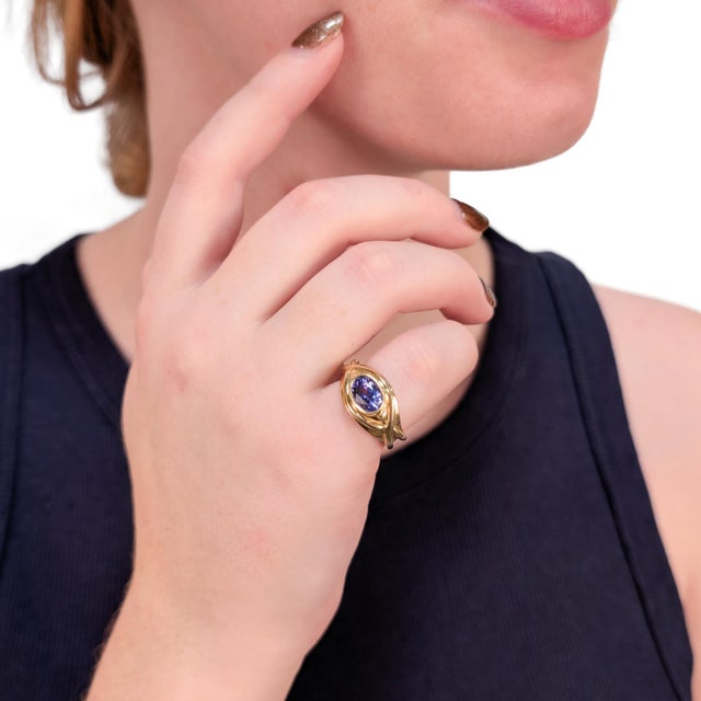 A fine vintage gold and tanzanite cocktail ring. With a bezel-set oval modified brilliant cut 1.74 Ct± tanzanite gemstone....