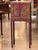 Red painted chinoiserie cabinet on a matching stand, decorated throughout with gilt landscape scenes, figures, birds, and...