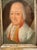 Pastel portrait of an older gentleman in a white wig and red-trimmed coat, presented in a painted oval within a...
