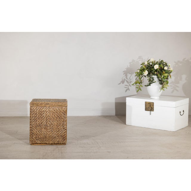 This vintage storage basket is constructed with a solid wood interior frame fully clad in tightly hand-woven rattan. The...