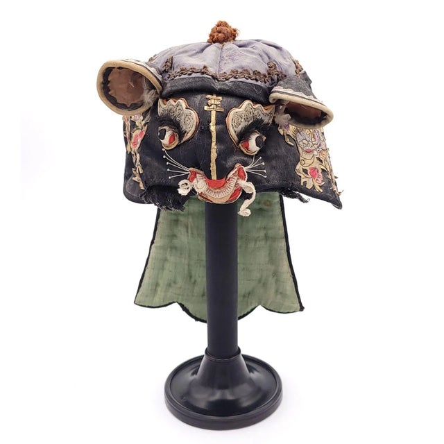 A Qing Dynasty zodiac rat embroidered mask, circa 1850 on later custom stand.