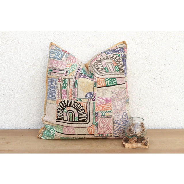 This 22-inch square pillow is a breathtaking example of Rajasthani textile art, handcrafted from rare antique Banjara...