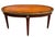 This Vintage French Louis XVI–style oval coffee table featuring a refined mixed-wood top framed by brass trim, is an...