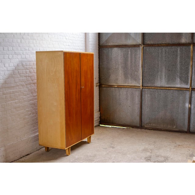 A mid-century wardrobe 'model kb03' with the deluxe option of teak doors marked with model number 'kb33', designed by cees...