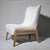 Verellen's Fernando Wing Chair in ivory bouclé on an exposed ash base. High-backed slipper silhouette with a subtle wing...