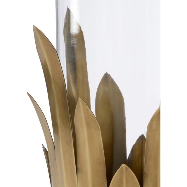Bring warmth to your home with this antique brass hurricane candleholder. Reminiscent of the bull rush cattail, the leaves...