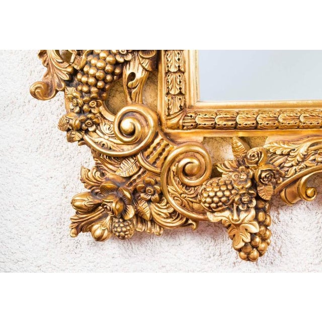 This is a superb very elaborate antique giltwood Florentine mirror dating from the last quarter of the 20th century. It is...