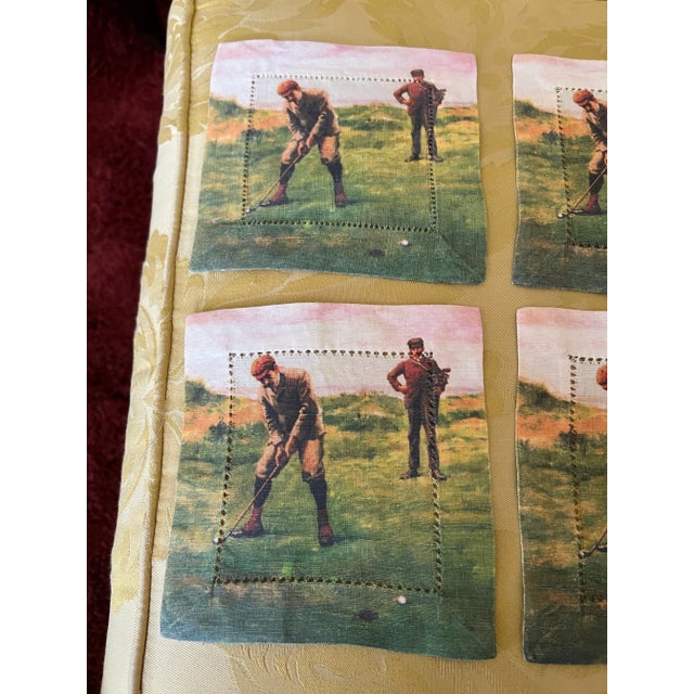 Set of six golf themed fabric square cocktail napkins. Features golfers in action on a green field.