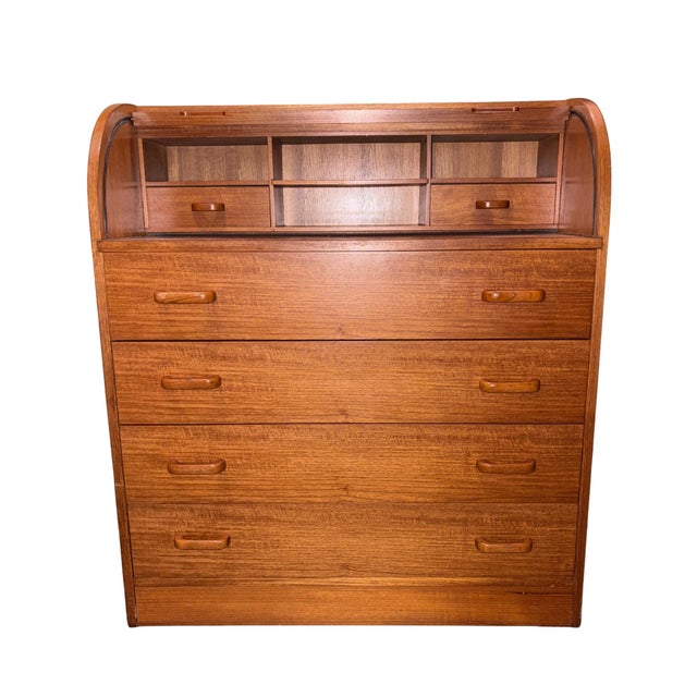 This is a vintage mid-20th-century Scandinavian Modern teak roll-top secretary desk and chest, which featuring a tambour...