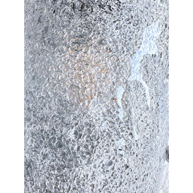 Contemporary luxury modern wall sconces made in transparent hammered Murano glass with a traditional working of...