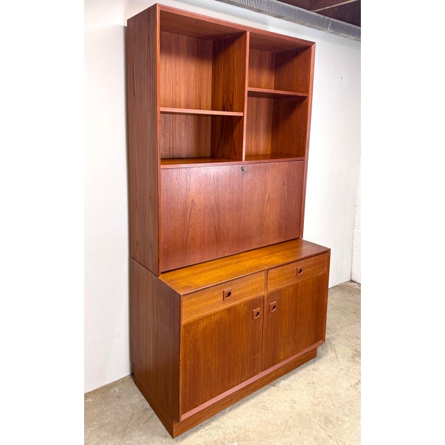 A fabulous teak wall unit / bookcase / cabinet / writing desk by Erik Brouer for Brouer Mobelfabrik circa 1960’s. Features...