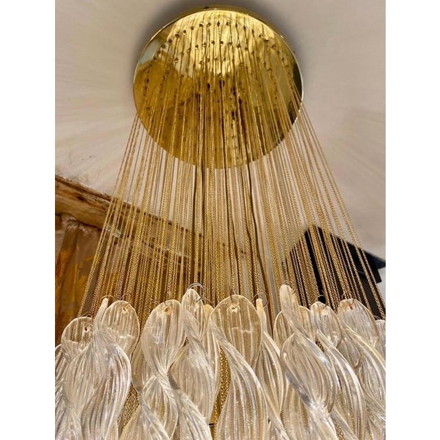 Exceptional cascade pendant with eclipse glass Murano by Mazzega oversized with gilt gold structure. The Design and the...