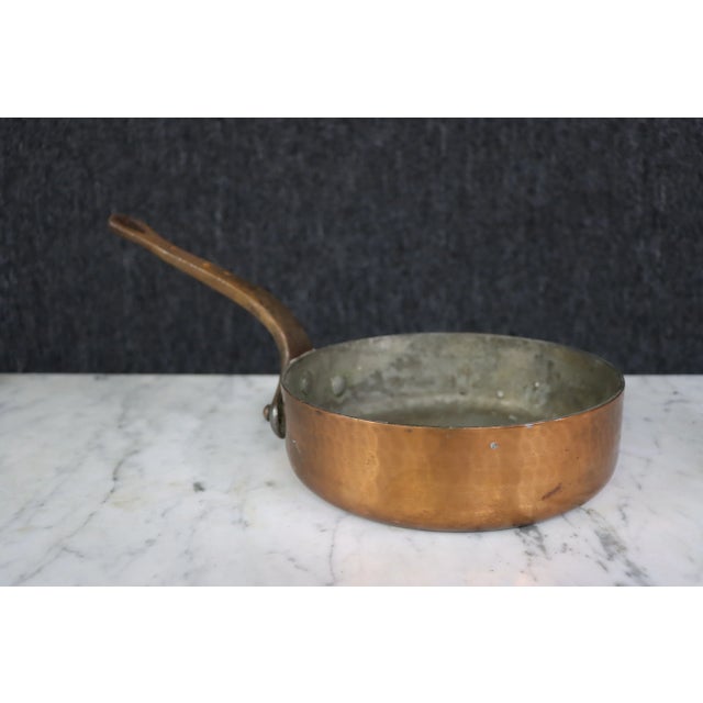 Copper Saute Pan, copper exterior with stainless steel interior, bent handle with looped opening at end. Handle measures...