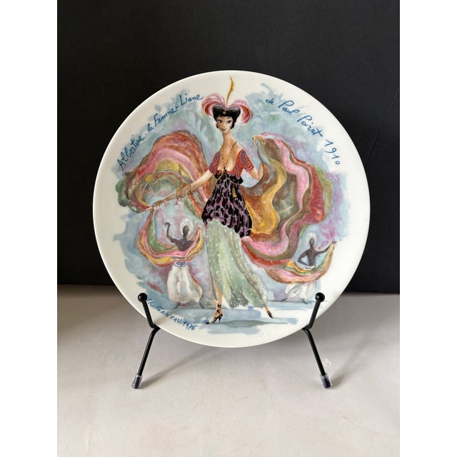 This elegant Limoges porcelain plate from D’Arceau’s Les Femmes du Siècle series captures the theatrical sophistication of...