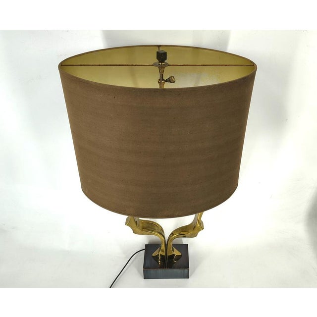 Bronze sculptural table lamp by Willy Daro. Elegant shape, letr your imagination work, we see silhouettes of two faces in...