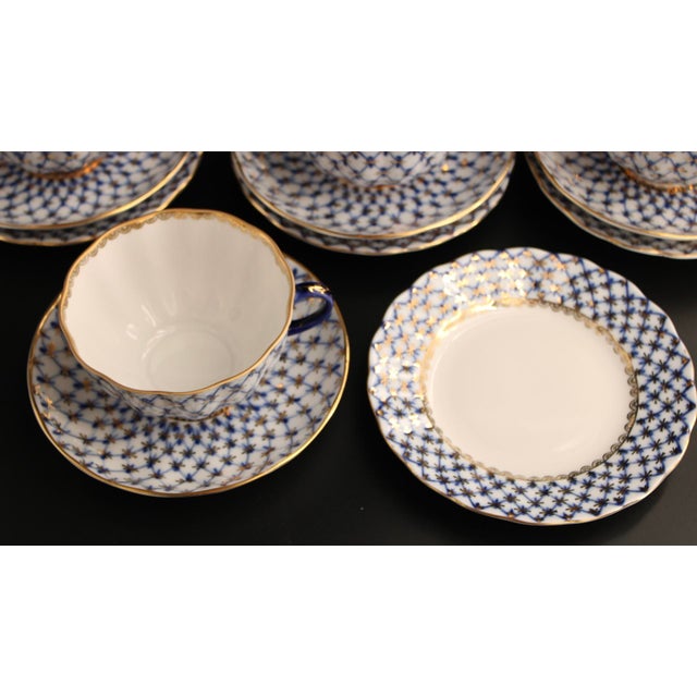 Authentic hand-painted porcelain tea set in the cobalt blue lattice weave pattern with 22 karat gold accents and rims....