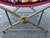 Add an exotic touch of historical romance to your home with this vintage Hollywood Regency campaign-style sling bench....