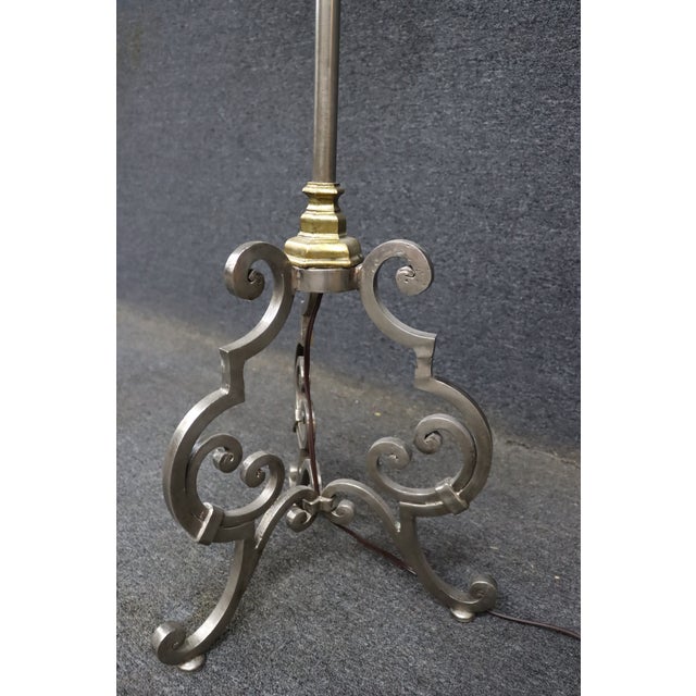 Directoire style floor lamp featuring an elegant mixed-metal design with a brushed stainless finish accented by brass...