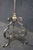 Directoire style floor lamp featuring an elegant mixed-metal design with a brushed stainless finish accented by brass...