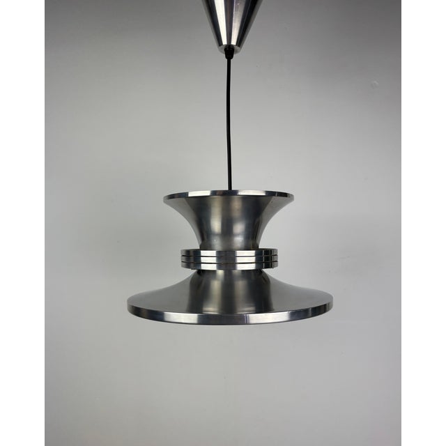 This exceptional danish pendant lamp from the 1970s embodies the bold, futuristic design language of the space age era....