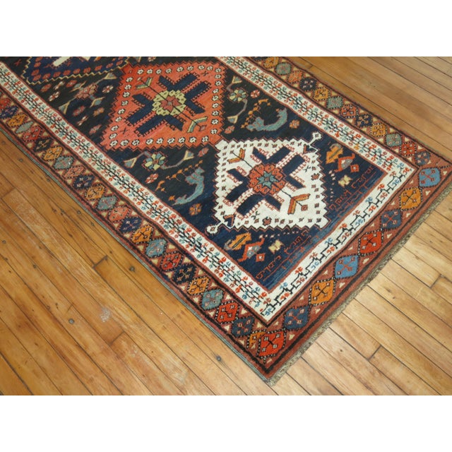 Early 20th century Persian Kurd runner with a bold geometric design on a navy ground Measures: 3'1' x 15'8".