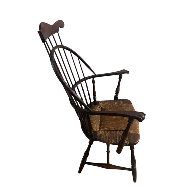The B&S Co Windsor Comb Back Arm Chair with a Rush Woven Seat is an antique piece that exudes vintage charm. Made in the...