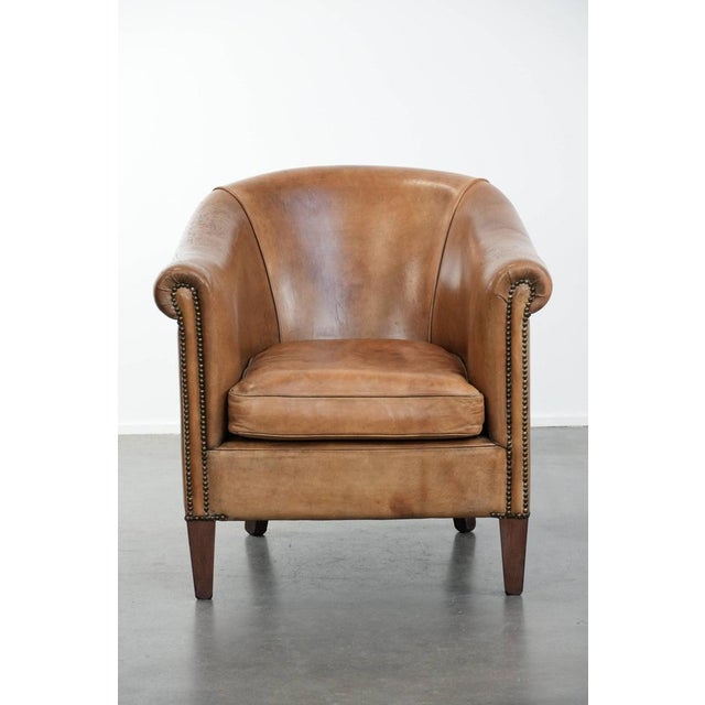 We are offering this distinctive club chair made of sheepskin leather in beautiful light cognac colors. This beautiful...