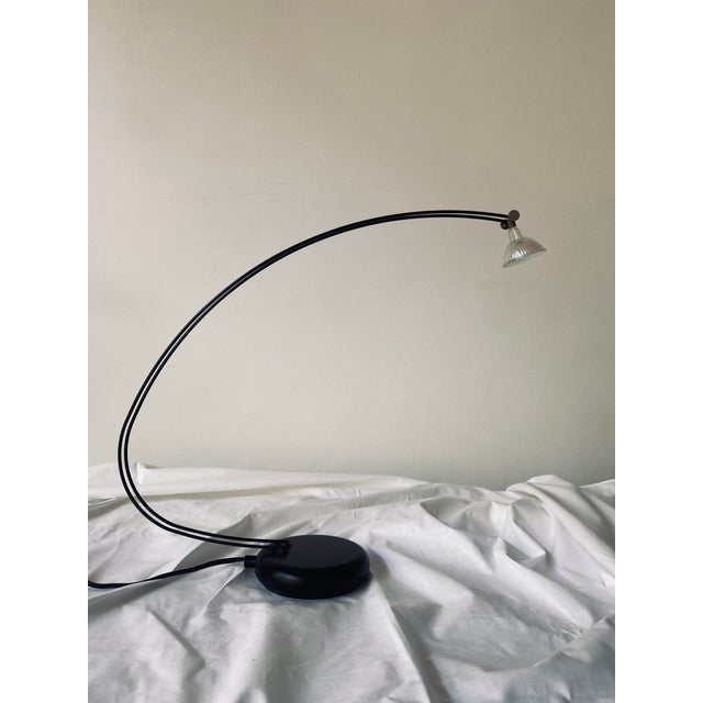 Postmodern table lamp. The reflector bulb is attached to two delicate rods that vibrate when touched. The bulb can be...