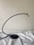 Postmodern table lamp. The reflector bulb is attached to two delicate rods that vibrate when touched. The bulb can be...