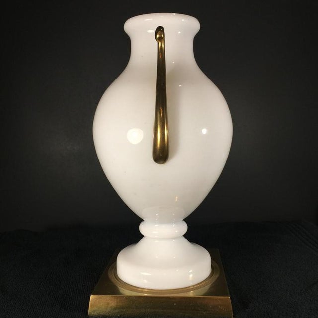 Primavera vase produced by venini, murano. White opaline glass body resting on a glass pedestal and a square chiseled...