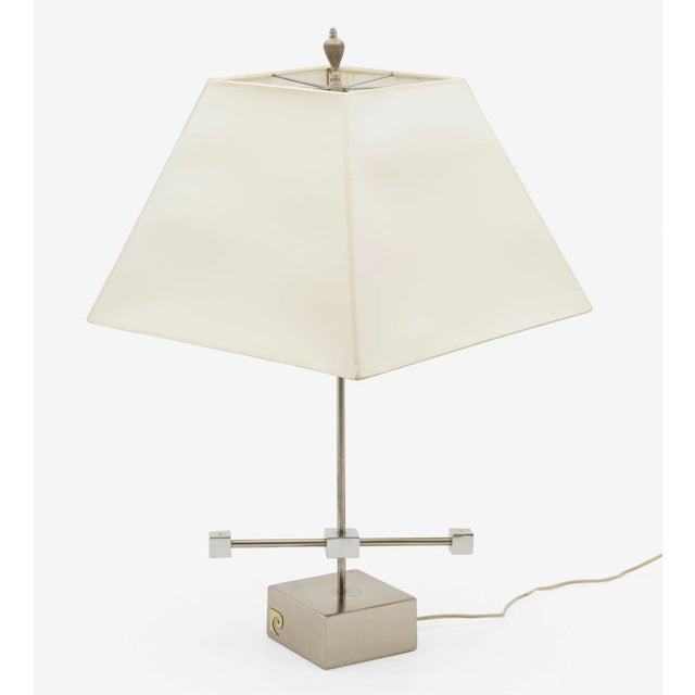 Pierre. Cardin chromed metal table lamp with a squared base and thin silhouette. The chrome barbell spins with a little...