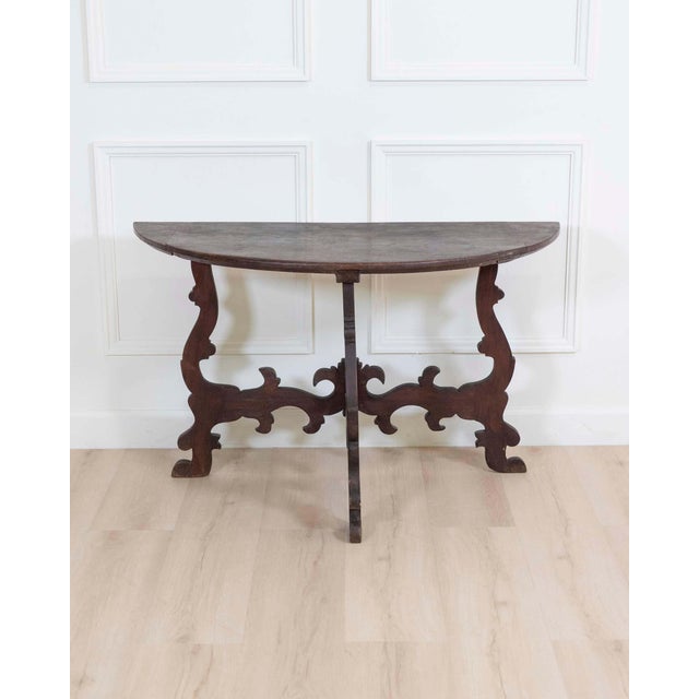 A striking 17th century chestnut console table, this antique piece showcases the bold craftsmanship and sculptural...