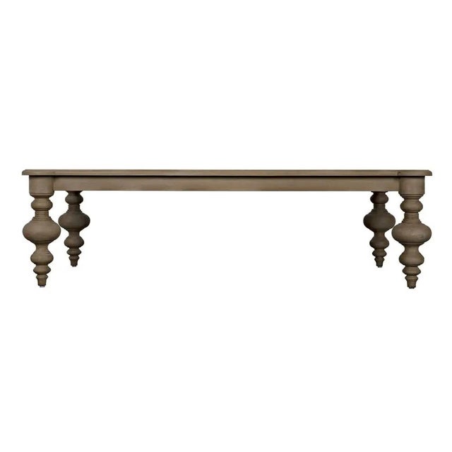 This sophisticatedly symmetrical coffee table features a rectangular mahogany top with rounded embellished corners that...