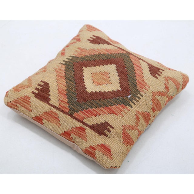 A one-of-a-kind handwoven Afghan wool kilim accent pillow featuring stepped diamond medallion. Cut and sewn by hand from a...
