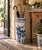 A classic blue and white porcelain umbrella stand in the chinoiserie tradition, featuring finely rendered birds among...