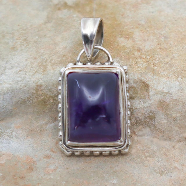 Amethyst and moonstone pendant set in sturdy sterling silver for a modern or tribal appeal. This piece encapsulates the...