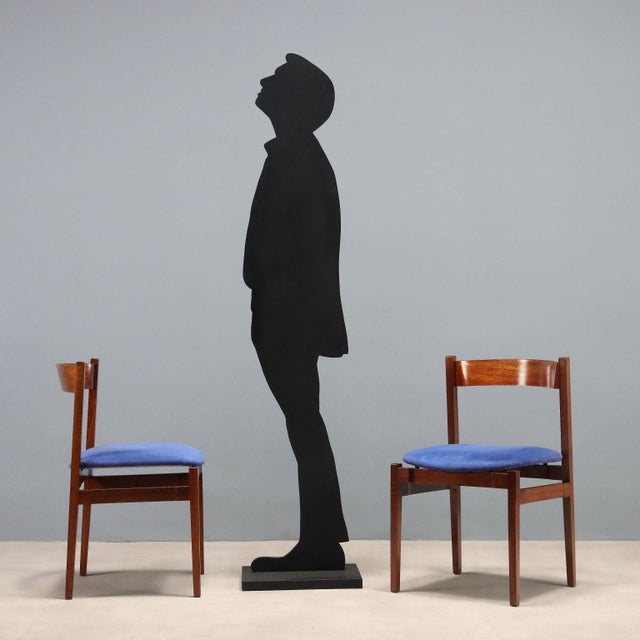 Set of four vintage dining chairs with exposed wooden frames, foam-padded seats, and original period blue fabric...