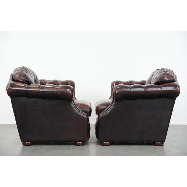 Set of two red-mottled English-style Chesterfield armchairs in good condition. : These delightful red-mottled English-...