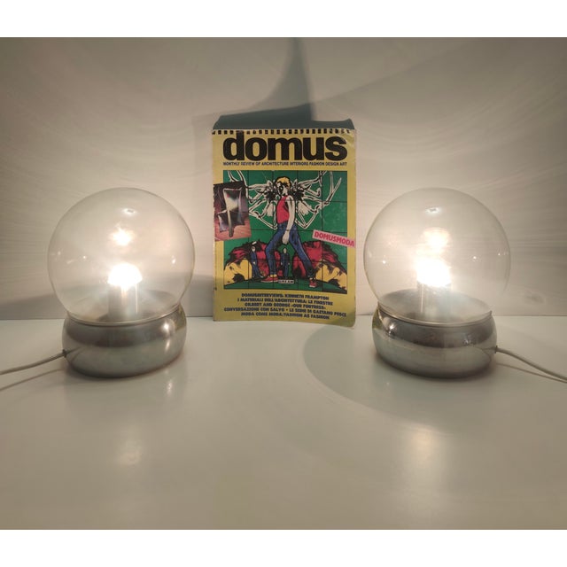 Made in Italy, 1970s. They feature a chrome-plated metal and aluminum structure with glass lampshades. These table lamps...
