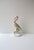 A white porcelain Heron bird sculpture decorative object with gold details, circa mid-20th century, Europe. A refined...
