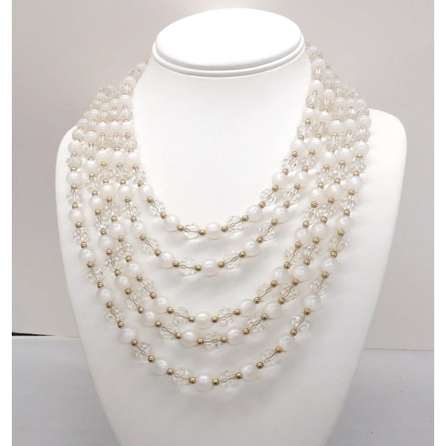 This is part of Chairish’s Costume Jewelry assortment. 1950s goldtone 5-strand round faux-moonstone and faceted glass...
