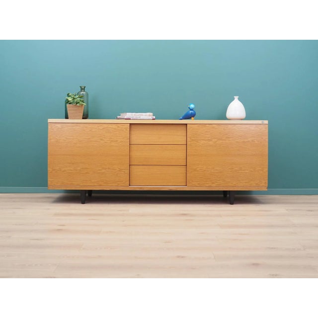 The sideboard was made in the 1990s, produced by the well-known Danish manufactory Skovby. The structure is covered with...