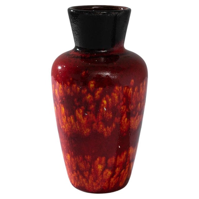 This striking 1960s German ceramic vase is a vibrant testament to the era's bold aesthetic and design ingenuity. The deep,...