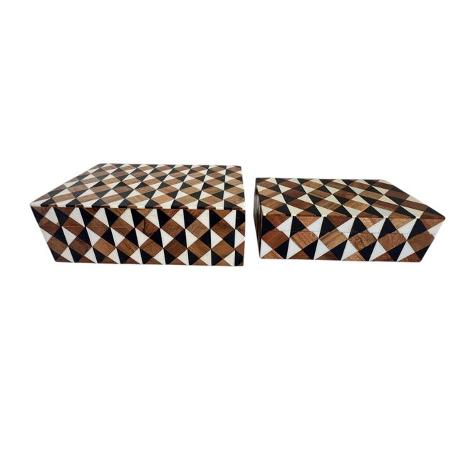 This product is a set of two inlaid geometric tri-color boxes, featuring a black, brown, and white design made of wood and...